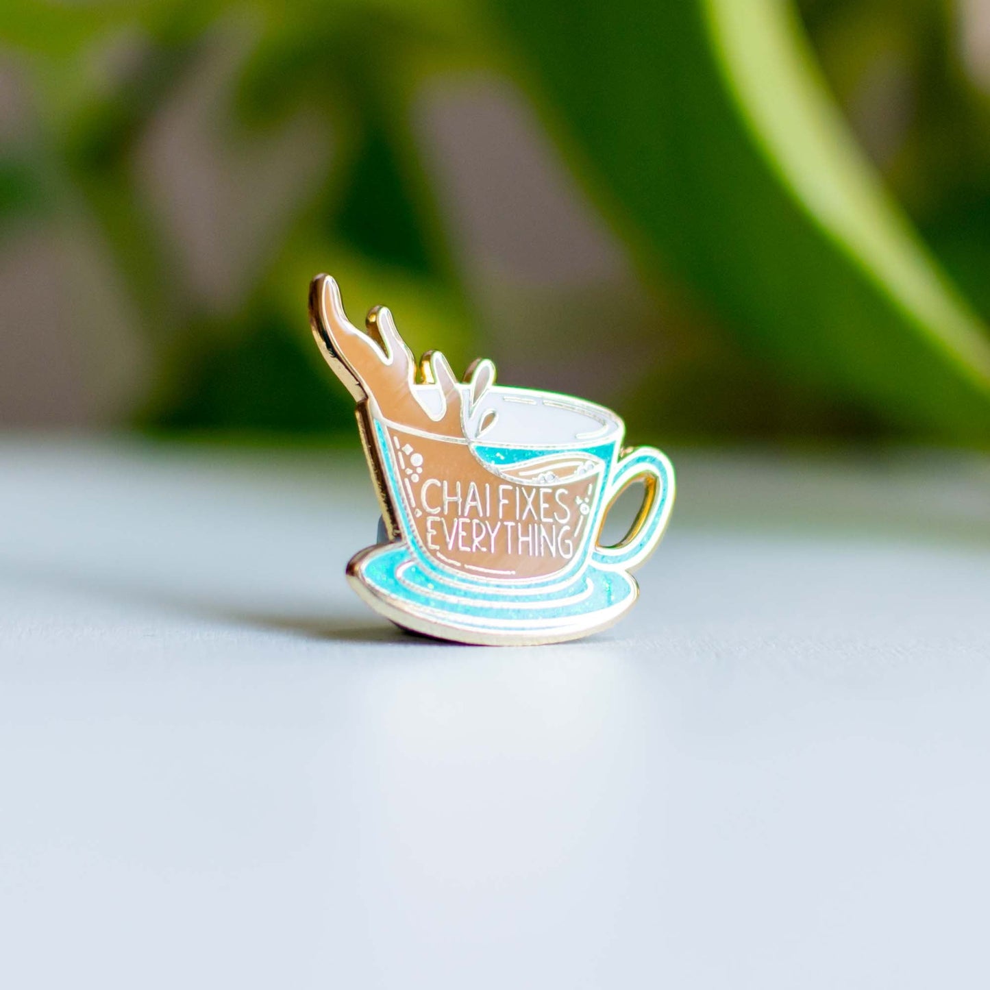 a cup of coffee with a leaf on top of it