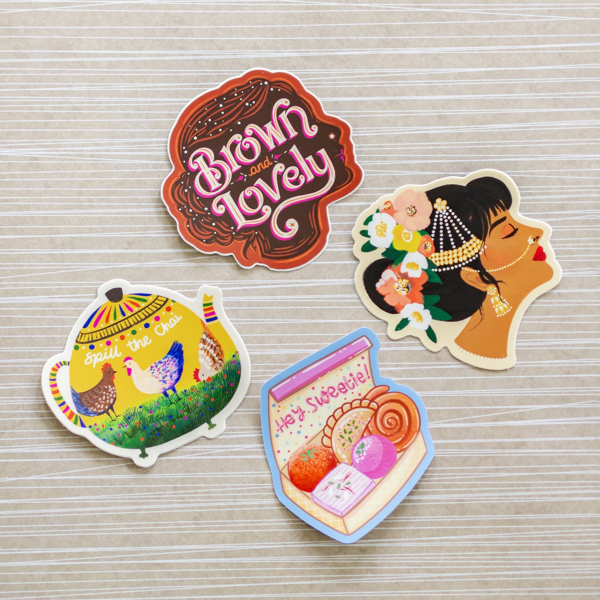 three stickers of different designs on a table