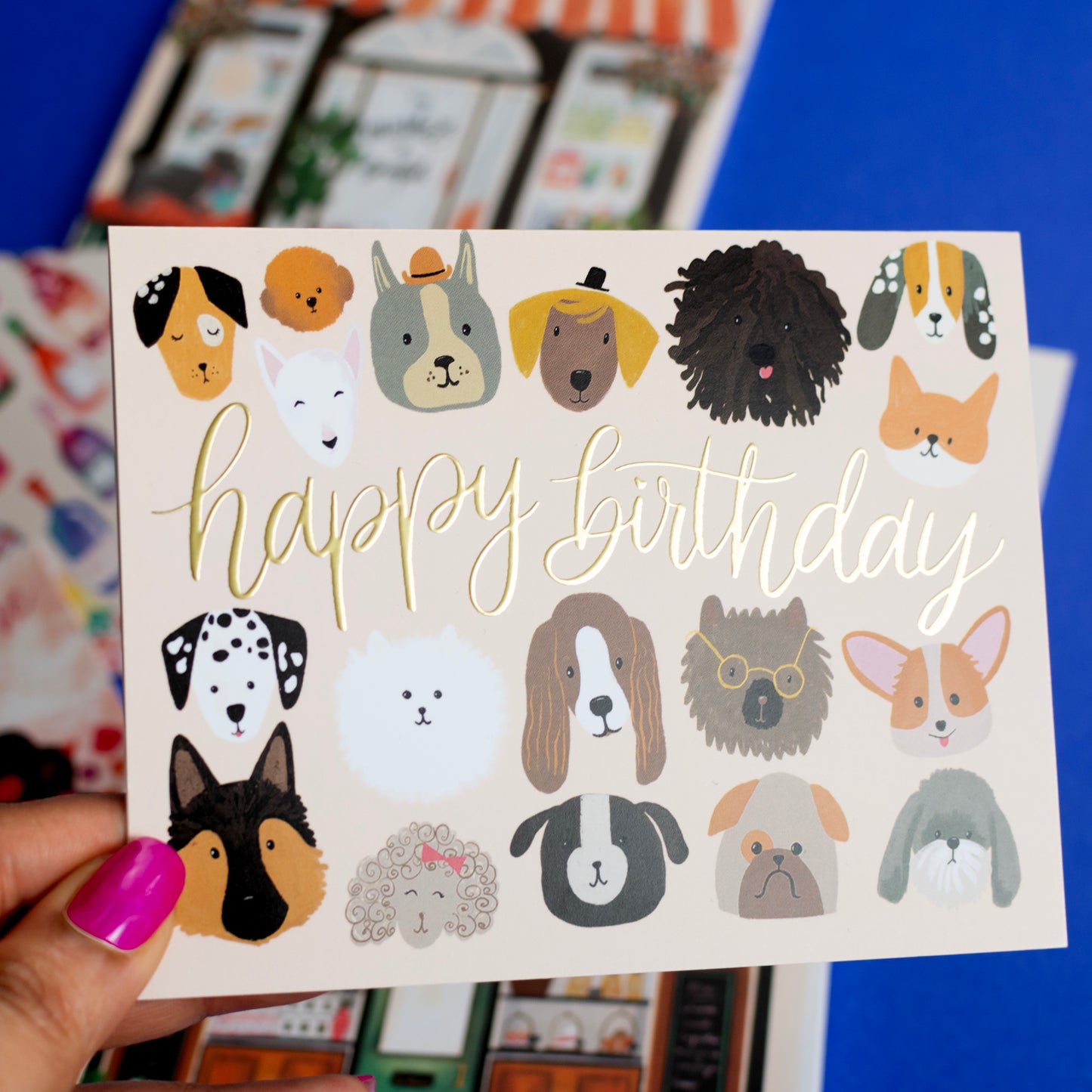 a person holding up a card with dogs on it