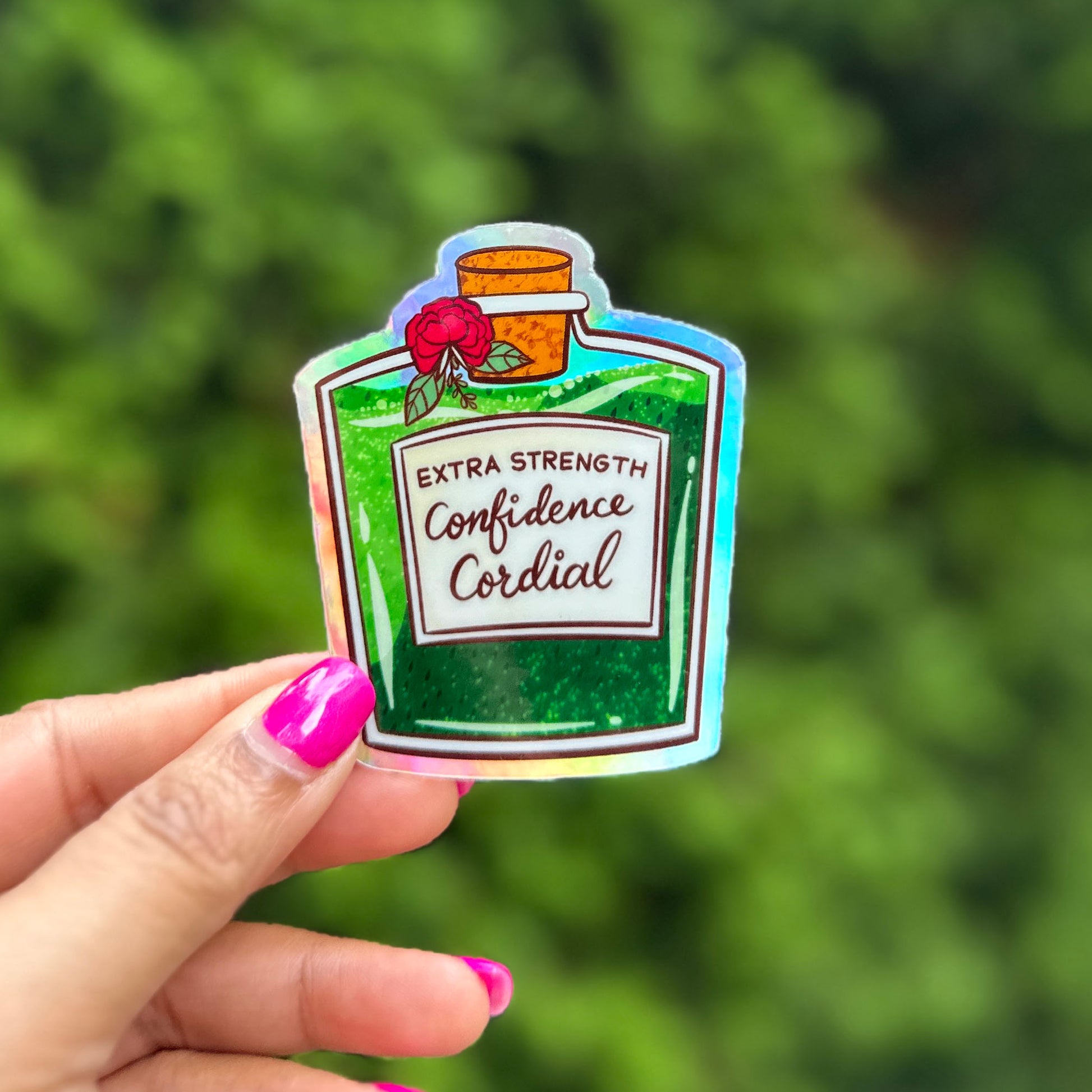 a hand holding a sticker of a bottle of condiment