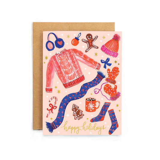 a pink card with a picture of a woman's outfit and a pair of