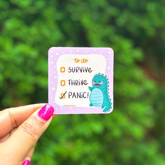 a person holding up a card with a picture of a dinosaur on it
