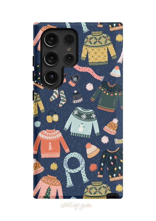 a phone case with a pattern of sweaters and hats