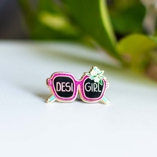 a pair of pink sunglasses with the word des girl written on them