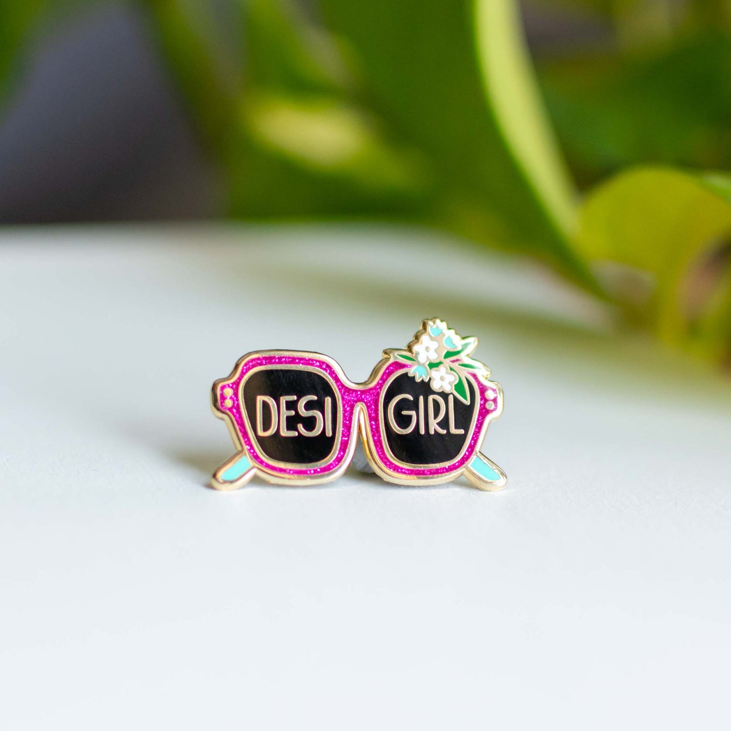 a pair of pink sunglasses with the word desi girl on them