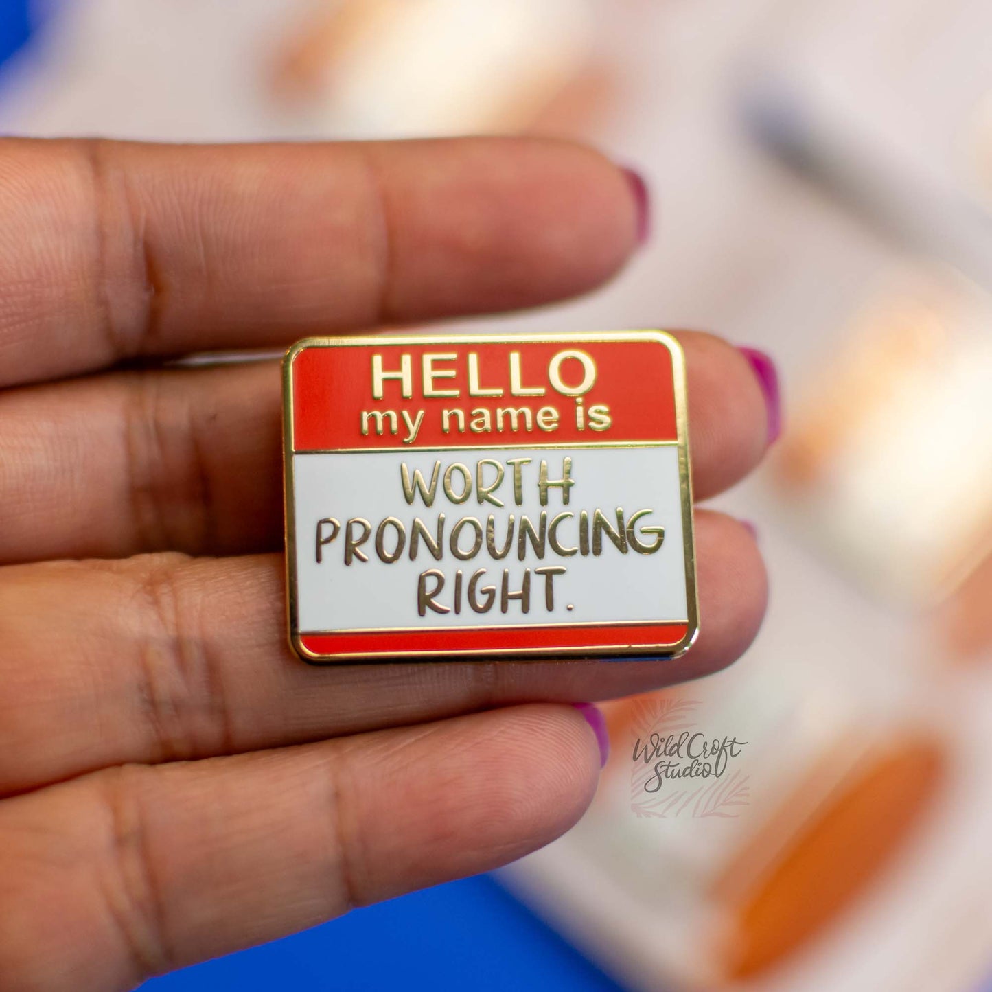 a person holding a sign that says hello my name is worth pronouncing