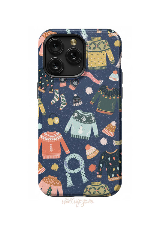 a phone case with a pattern of sweaters and hats