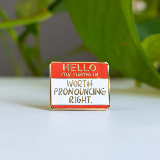 a red and white sign that says hello my name is worth pronouncing