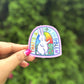 a person holding a sticker with a picture of a rabbit on it