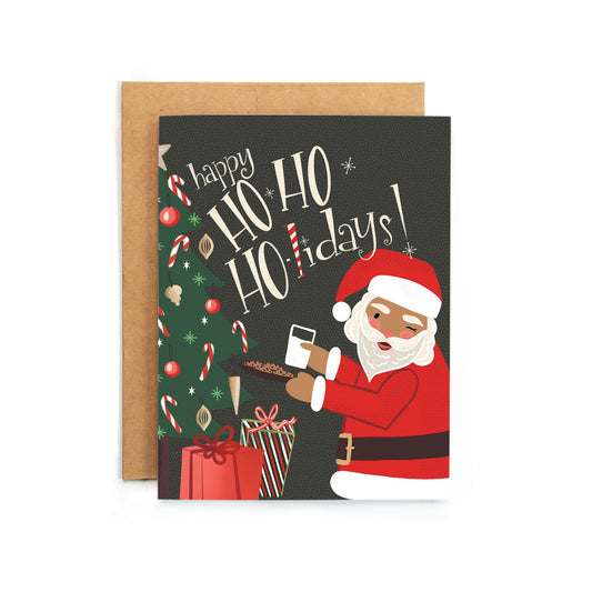 a christmas card with a santa clause holding a gun
