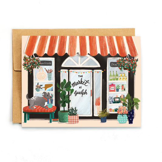 a card of a store front with a cat sitting on a bench
