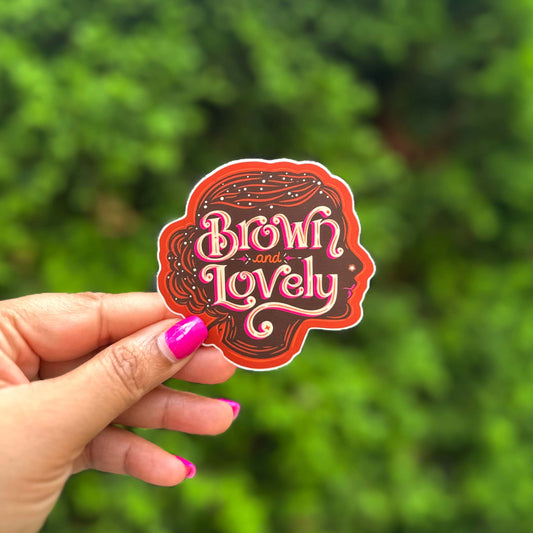 a hand holding a sticker that says brown lovely