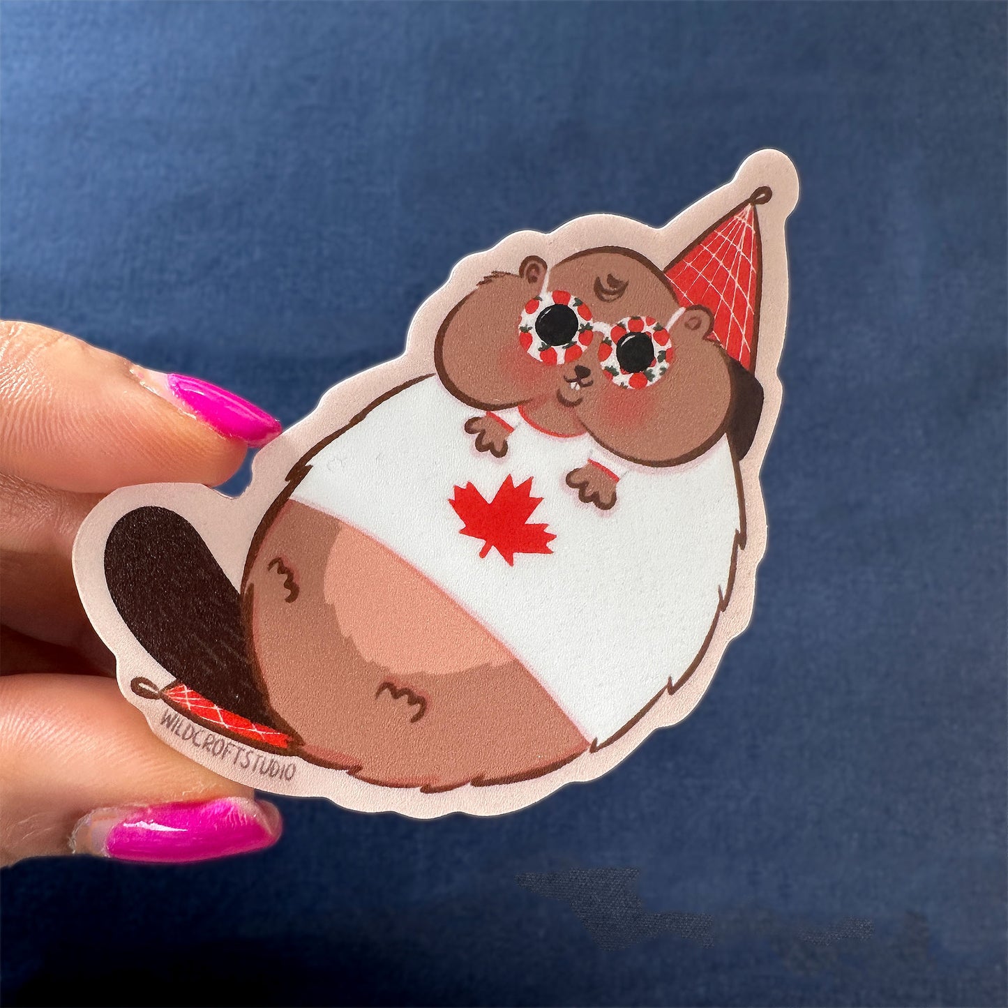 a person holding a sticker with a bear on it
