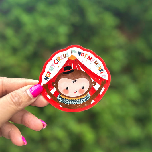 a person holding up a small monkey shaped ornament