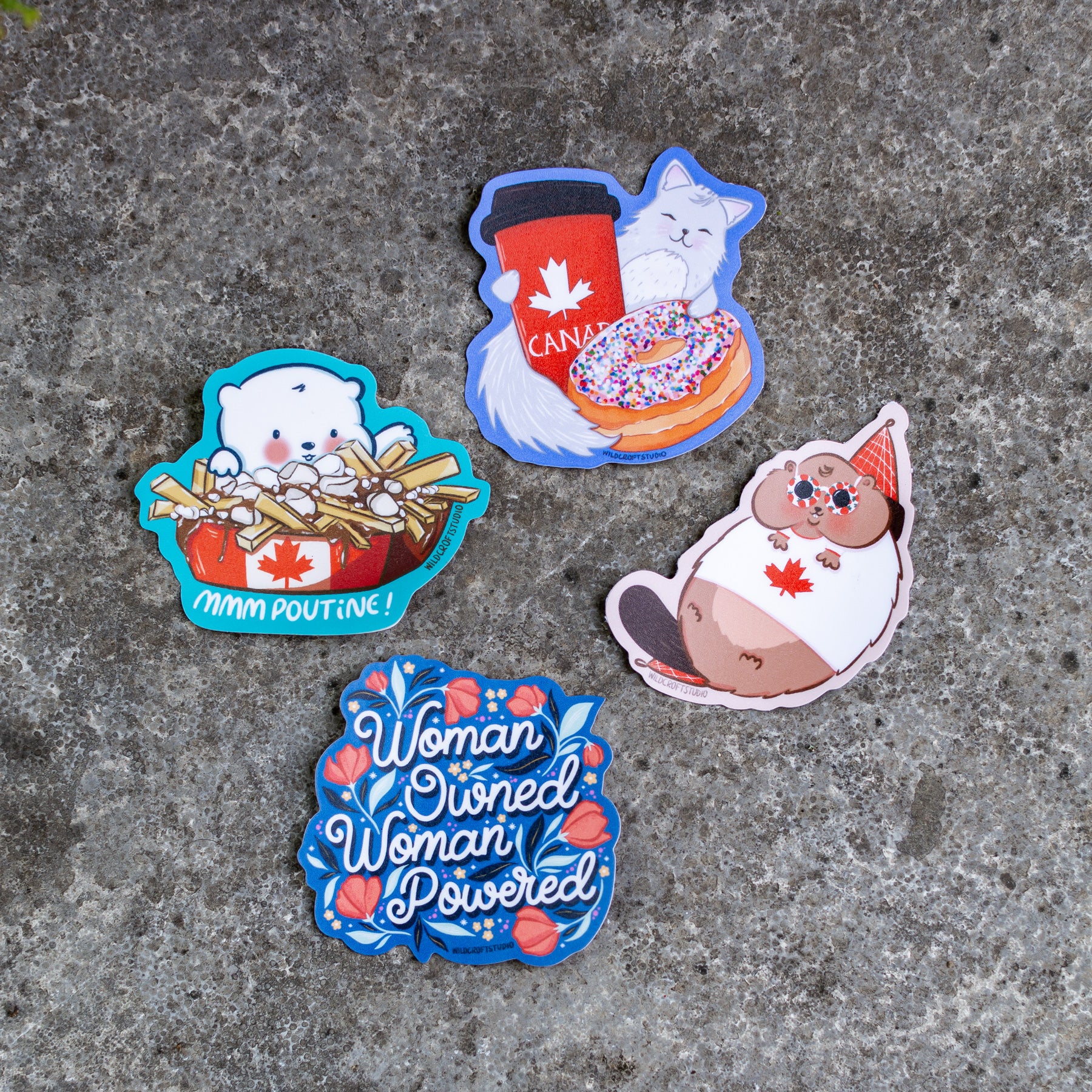 three stickers of different kinds of food on a concrete surface