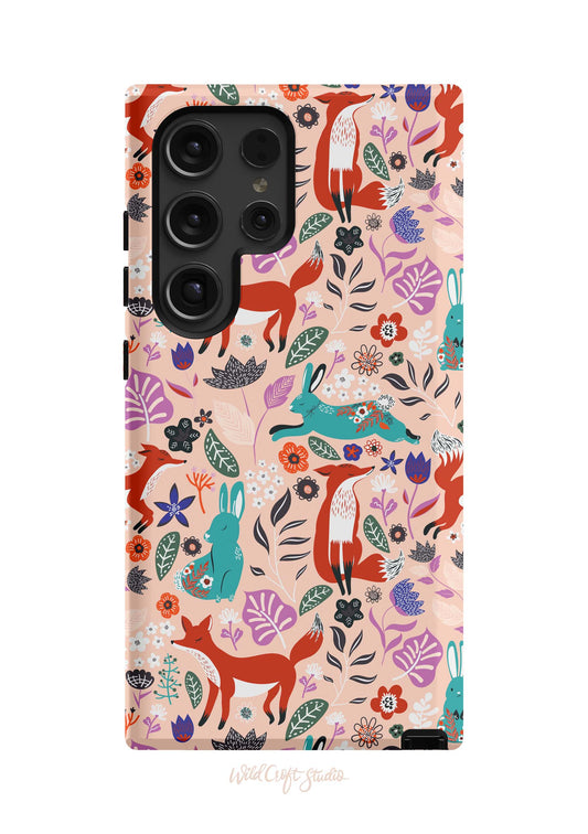 a phone case with a pattern of foxes and flowers