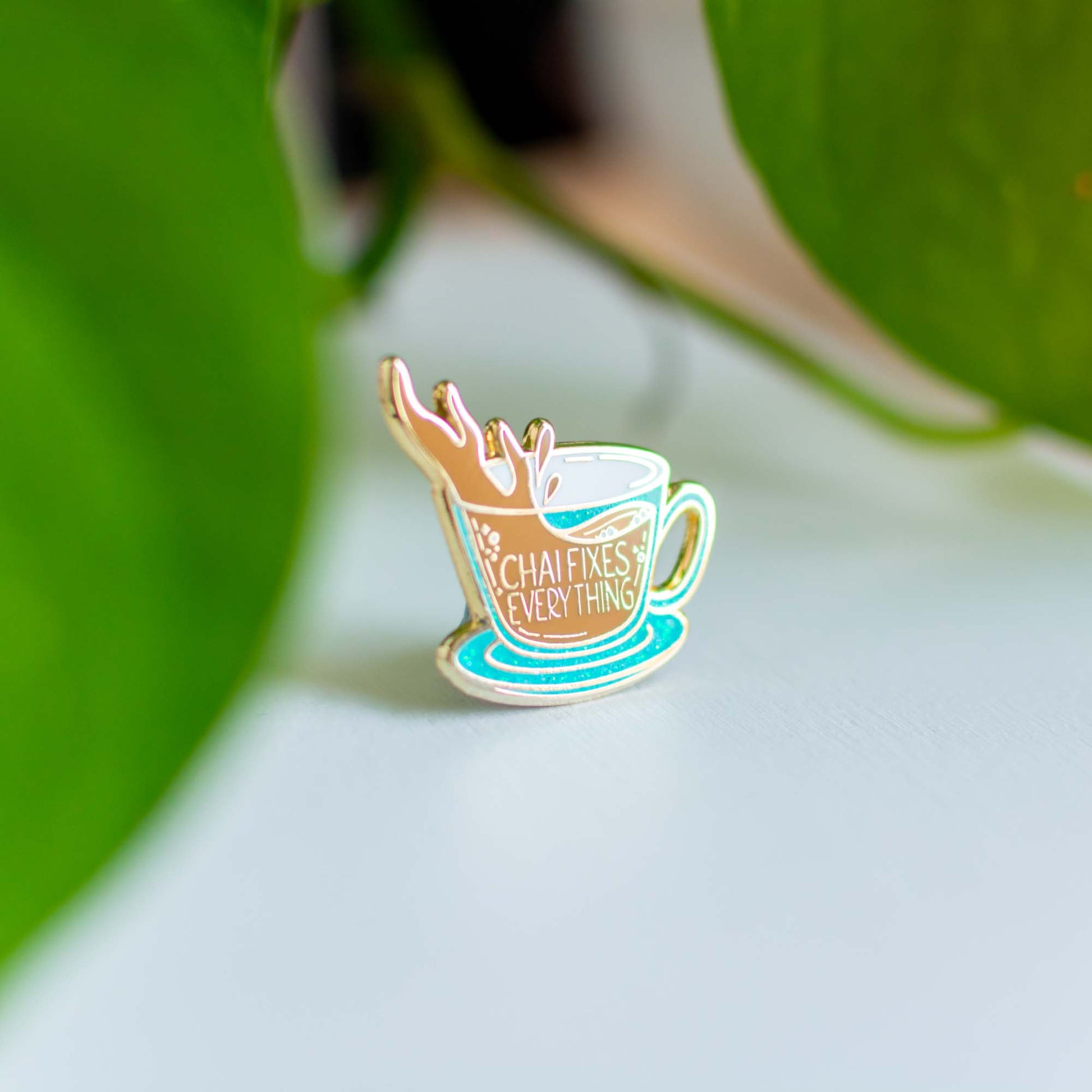 a coffee cup pin sitting on top of a table