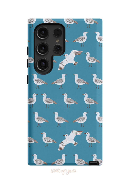 a phone case with seagulls on a blue background