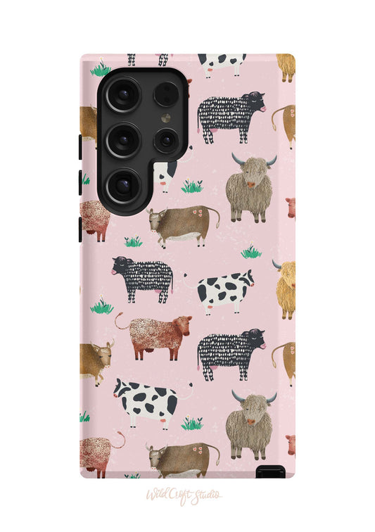 a pink phone case with cows on it