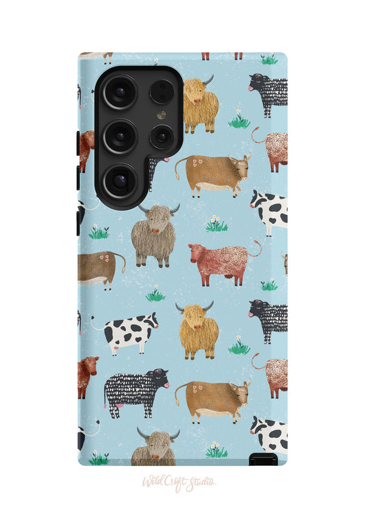 a phone case with cows on a blue background
