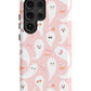 a pink phone case with ghost faces on it